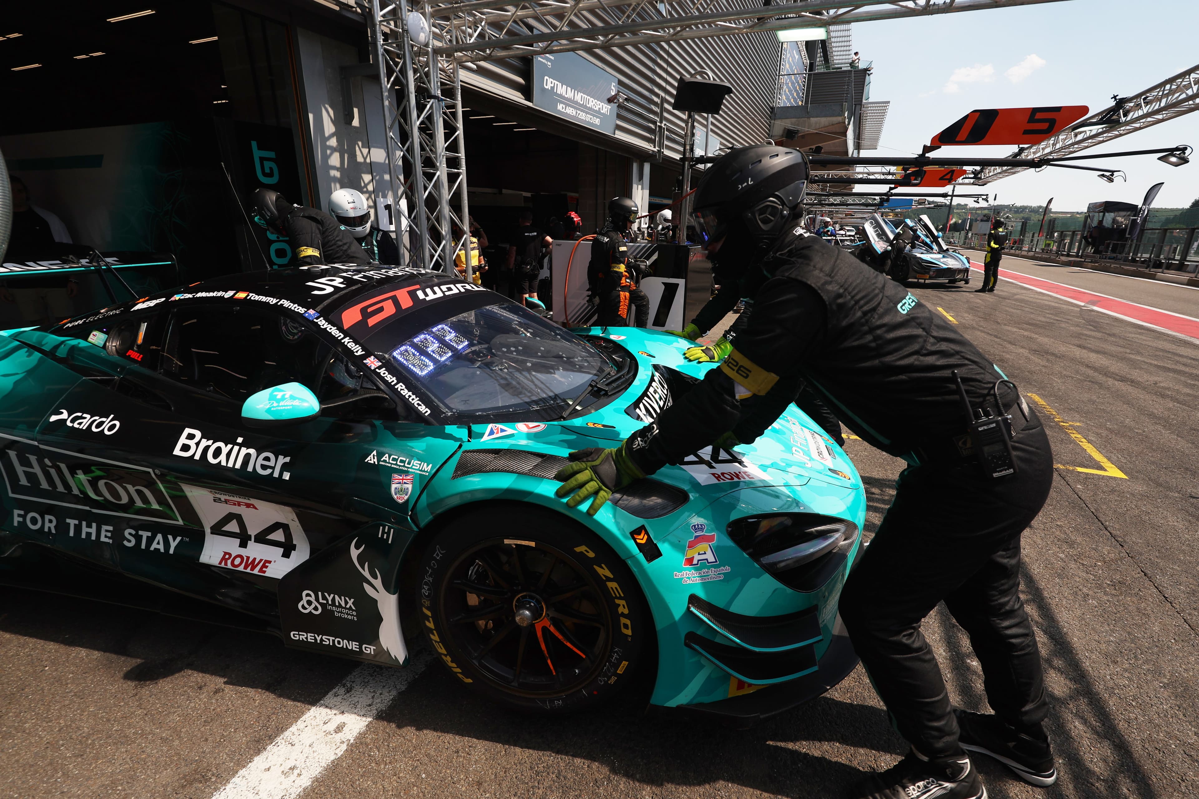 Greystone Mechanics wheel car into the garage during a practice session 