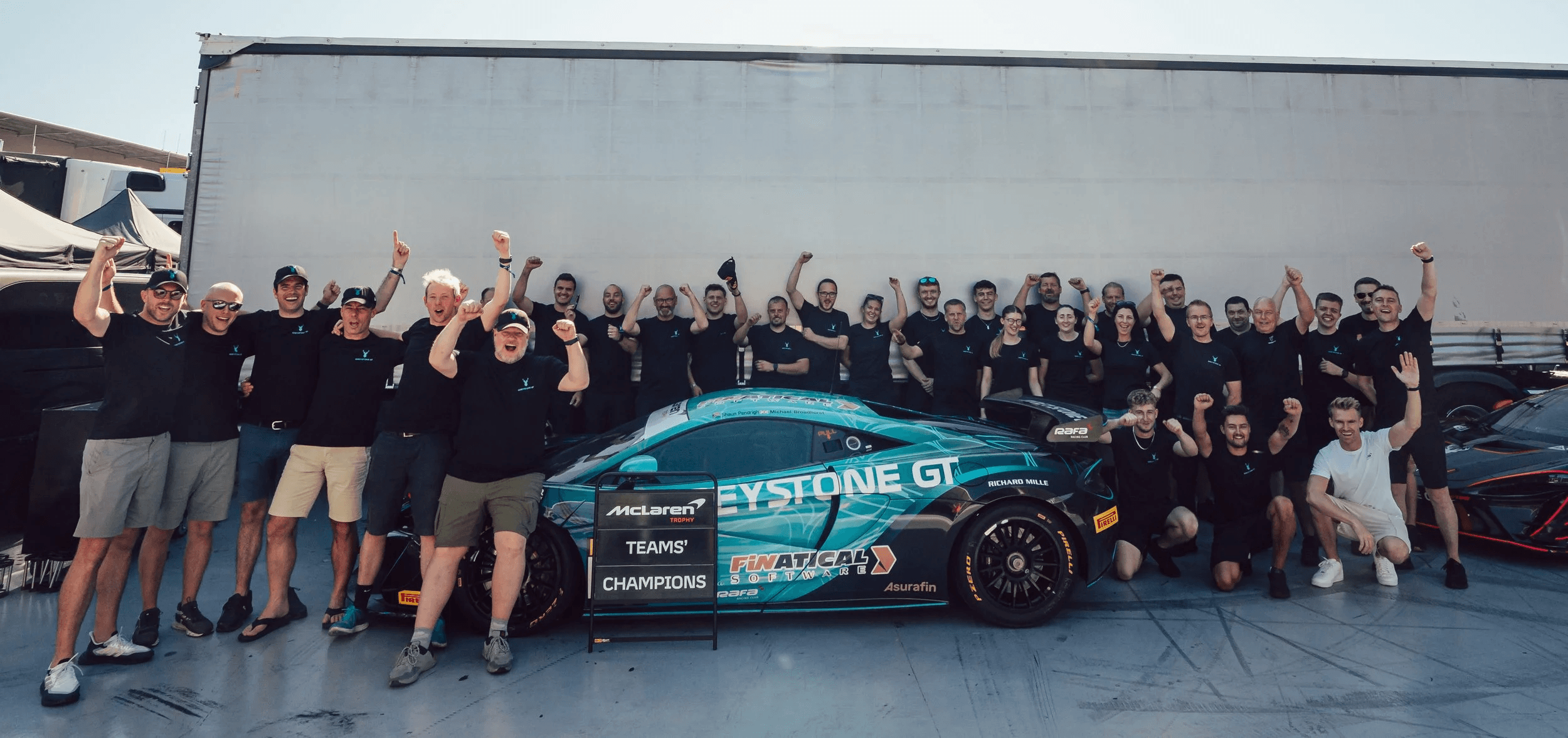 team Celebrating in-front of their Artura Trophy Car